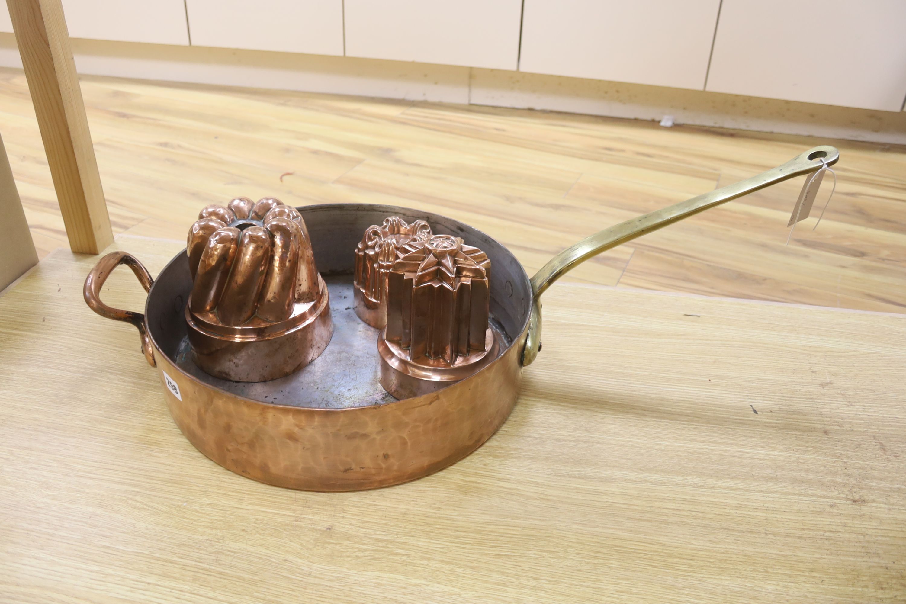 A Victorian Benham & Froude copper jelly mould, 11cm high, two others, 16.5cm high and a copper preserving pan